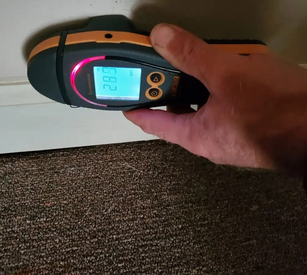 Moisture detection at baseboard during Storm Damage Restoration in Belleville